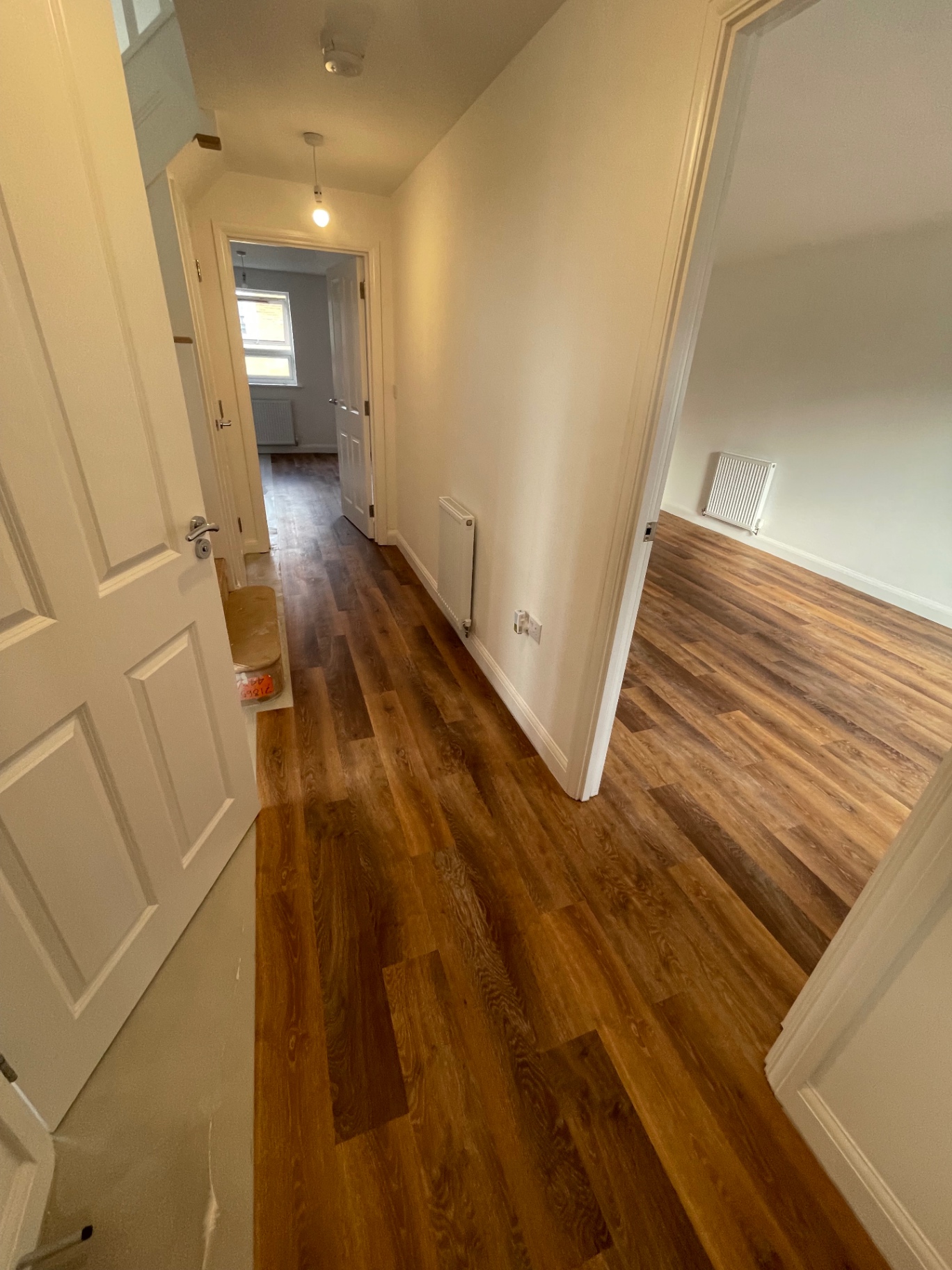 Newly renovated hallway with fresh decoration and wood-effect flooring