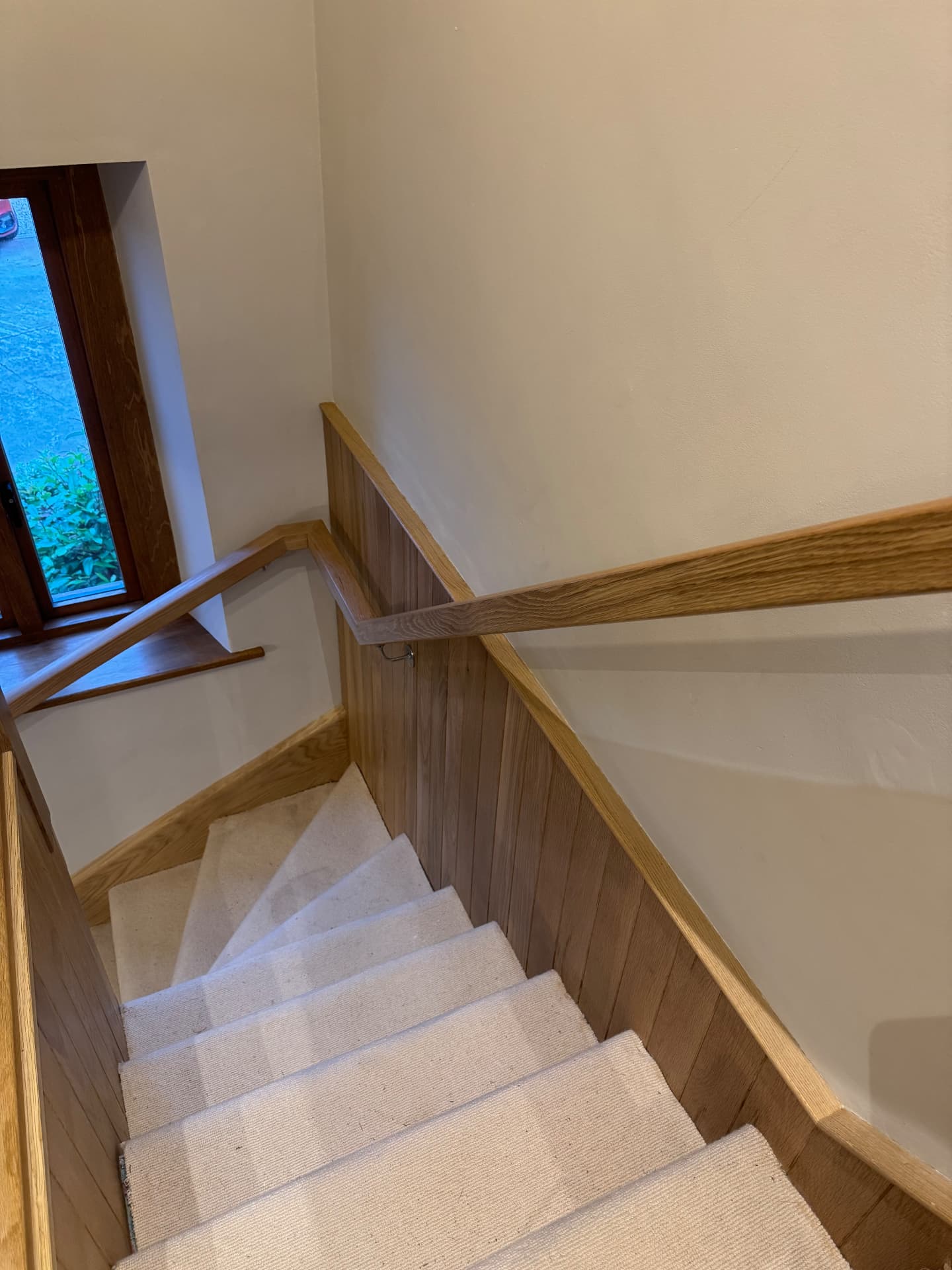 Oak panelled stairwell with matching handrail