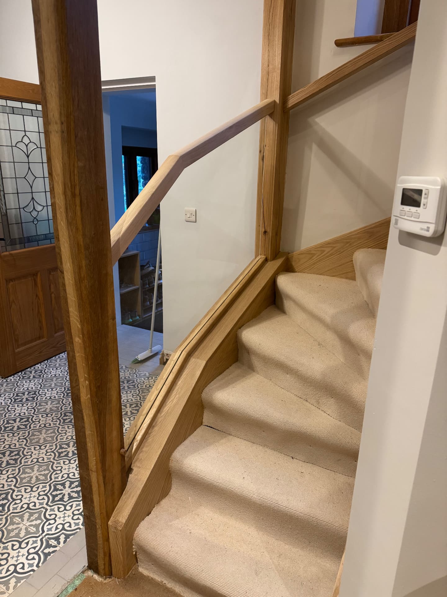 Oak handrail and newel post in a renovated hallway